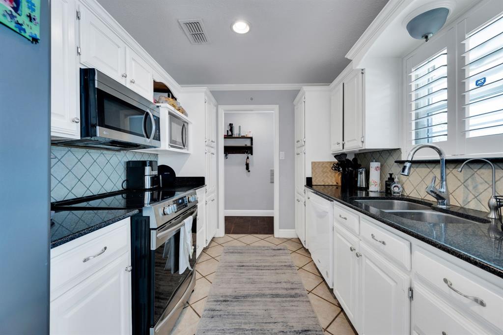 2263 Old Dicey Road Weatherford, TX 76085 - Photo 8 of 40 a kitchen with stainless steel appliances granite countertop a sink and a stove