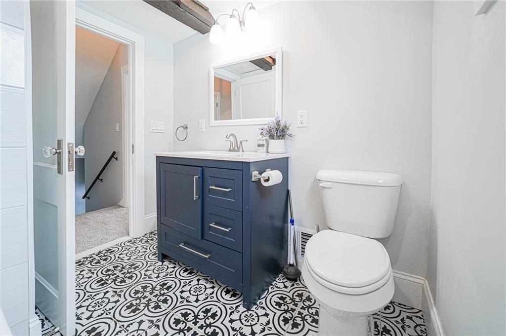 671 Old Rte 8 Harrisville, PA 16038 - Photo 40 of 49 a bathroom with a toilet a sink and mirror