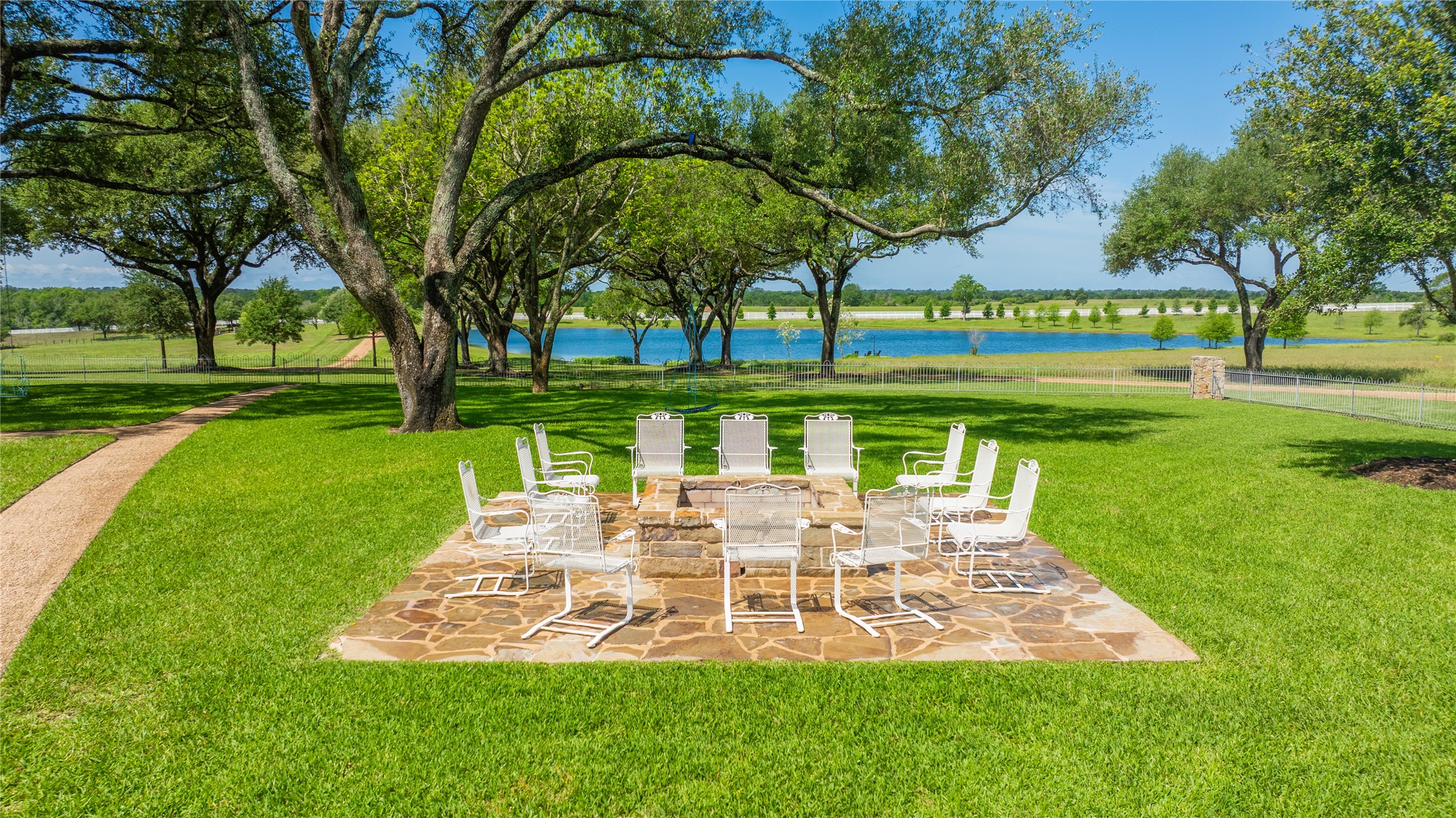 2228 Center Hill Road Bellville, TX 77418 - Photo 35 of 50 Outdoor seating area off the guest house, main house, camper, and garage overlooking the pond.
