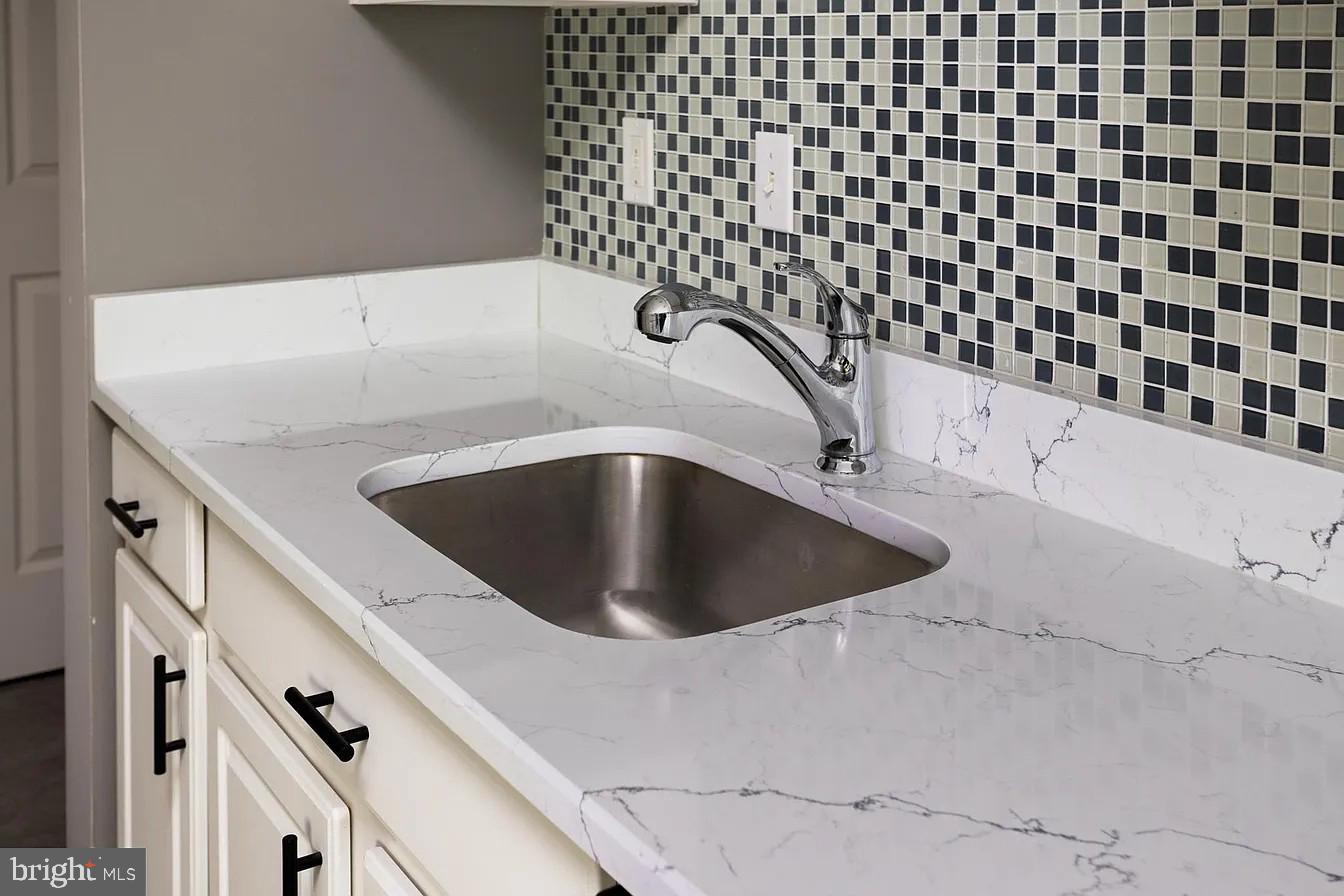 433 Mowat Circle Hamilton, NJ 08690 - Photo 15 of 36 Sleek marble countertop with mosaic tiles.