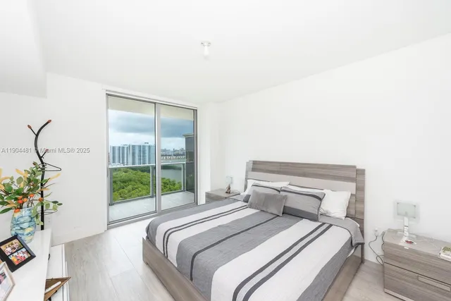 a bedroom with a bed and a potted plant