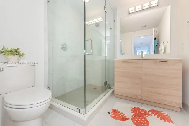 a bathroom with a toilet a sink and shower