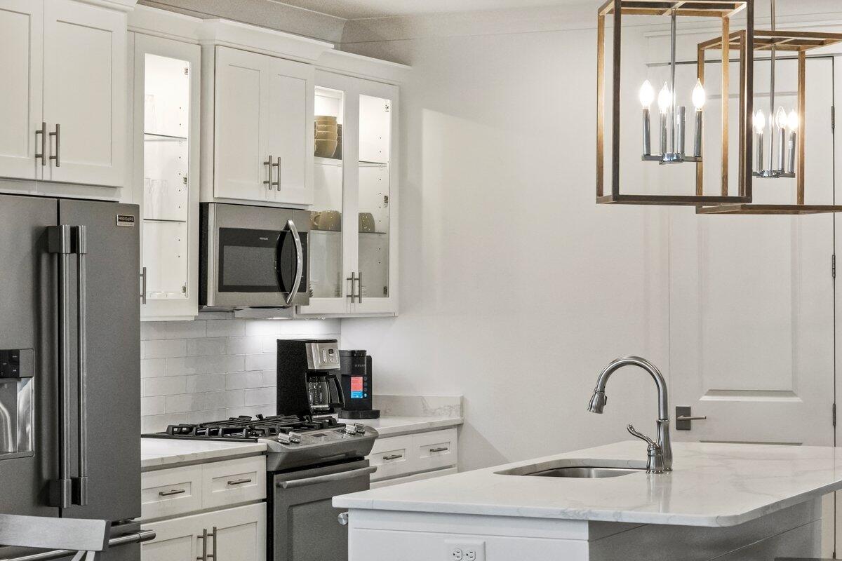 46 Lake Street Miramar Beach, FL 32550 - Photo 14 of 56 a kitchen with white cabinets a sink and appliances