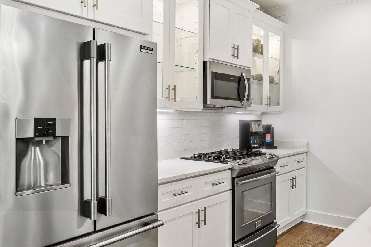46 Lake Street Miramar Beach, FL 32550 - Photo 15 of 56 a kitchen with white cabinets and stainless steel appliances