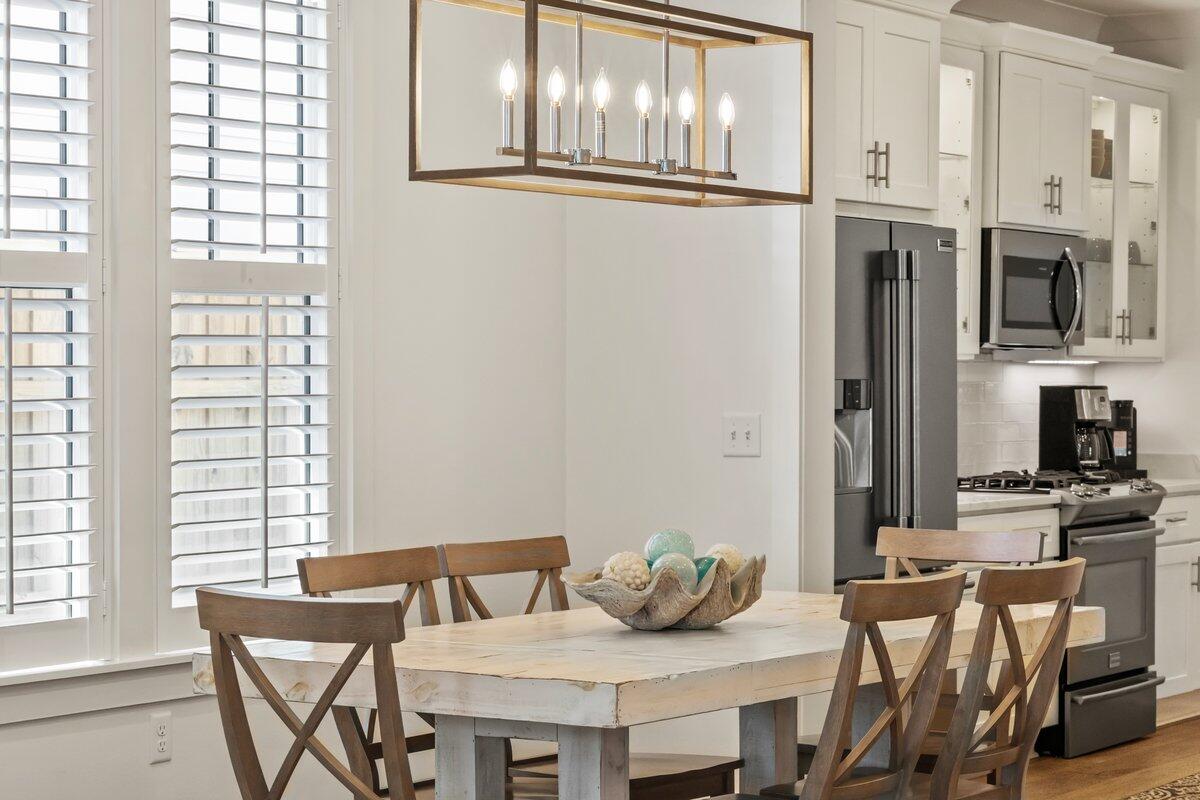 46 Lake Street Miramar Beach, FL 32550 - Photo 17 of 56 a view of a dining room with furniture and chandelier