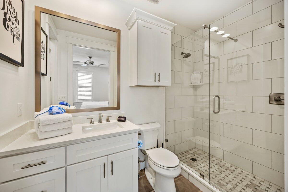 46 Lake Street Miramar Beach, FL 32550 - Photo 39 of 56 a bathroom with a sink toilet a mirror and shower