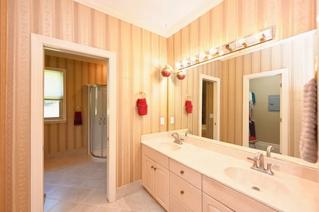 a bathroom with a double vanity sink and a mirror