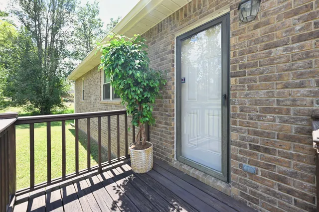 a view of balcony with wooden floor