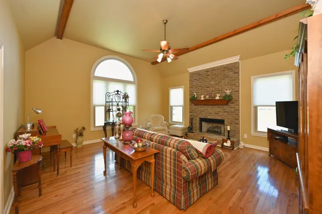 a living room with fireplace furniture and a chandelier