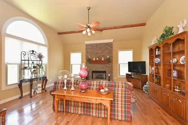 a living room with fireplace furniture and a flat screen tv