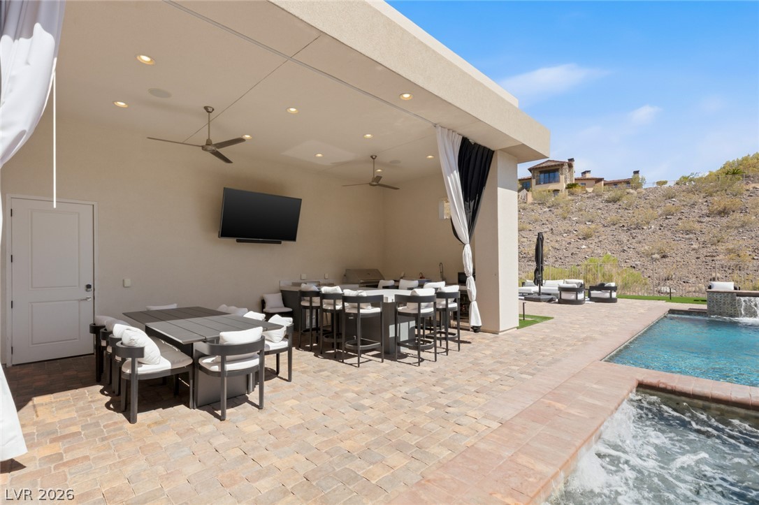 5 Crystal Tree Pass Henderson, NV 89052 - Photo 40 of 67 An inviting outdoor living area, perfect for entertaining with a full kitchen, dining space, and refreshing pool.