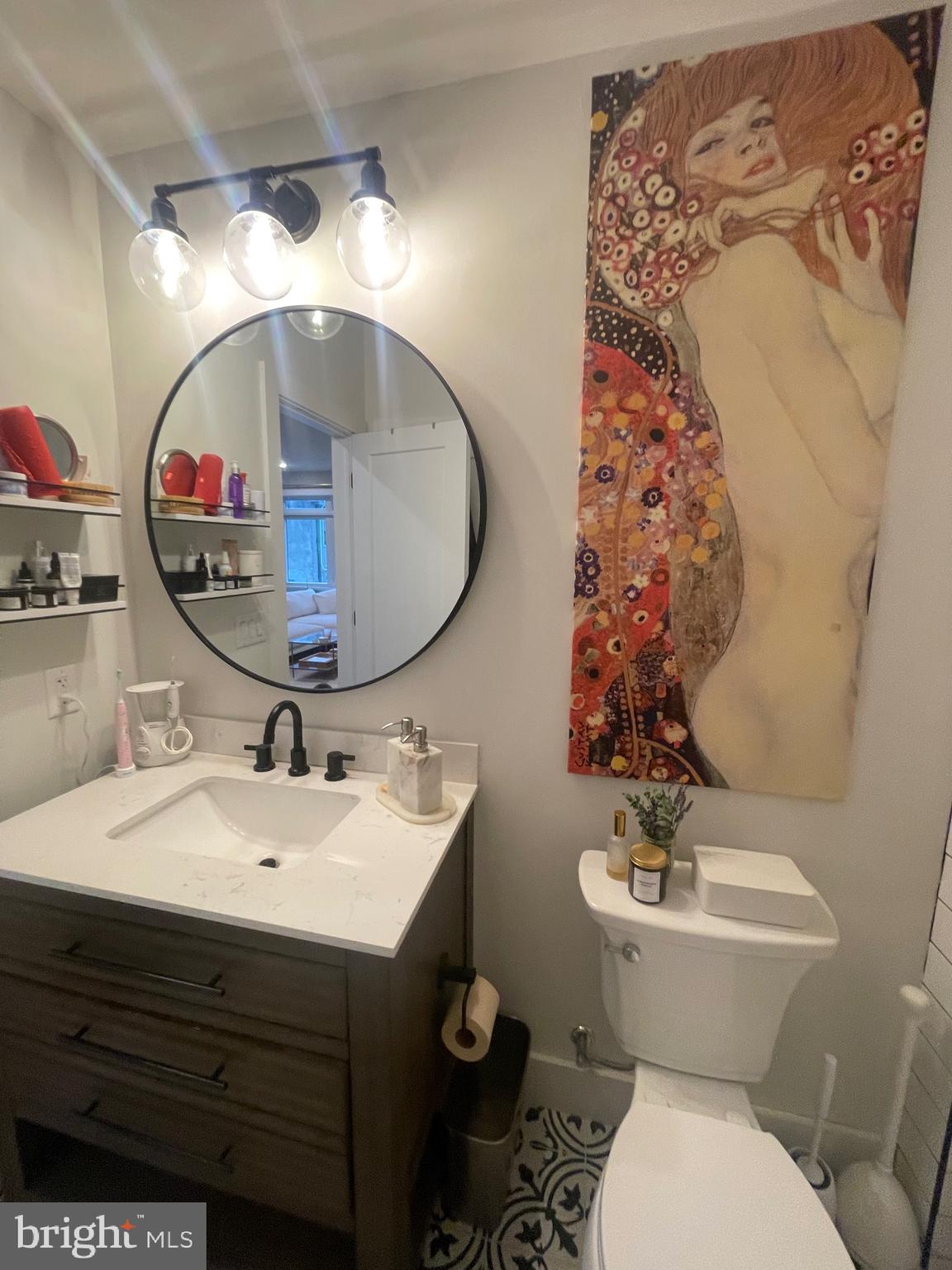 4007 Ridge Avenue Philadelphia, PA 19129 - Photo 14 of 14 a bathroom with a toilet sink and mirror