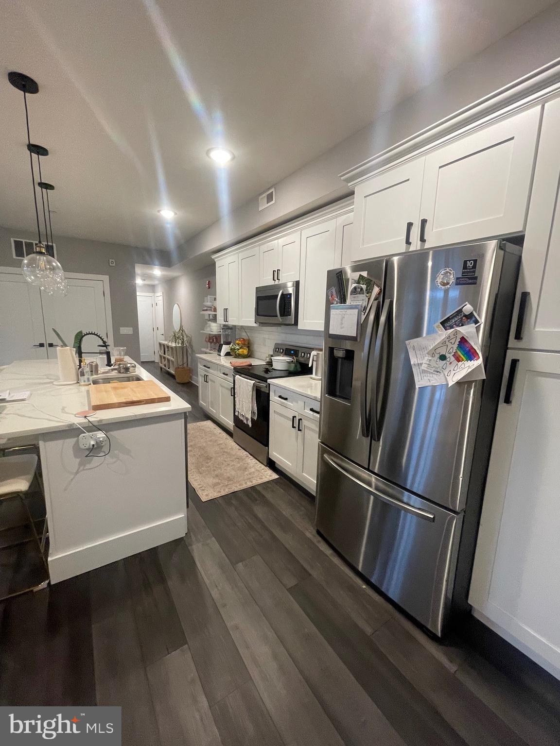 4007 Ridge Avenue Philadelphia, PA 19129 - Photo 8 of 14 a kitchen with stainless steel appliances sink refrigerator microwave and stove
