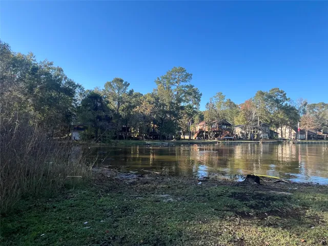 a view of a lake with houses in the back