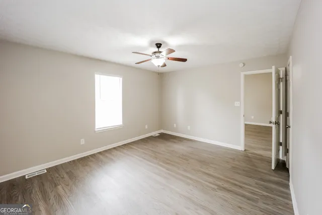 wooden floor in an empty room with a window