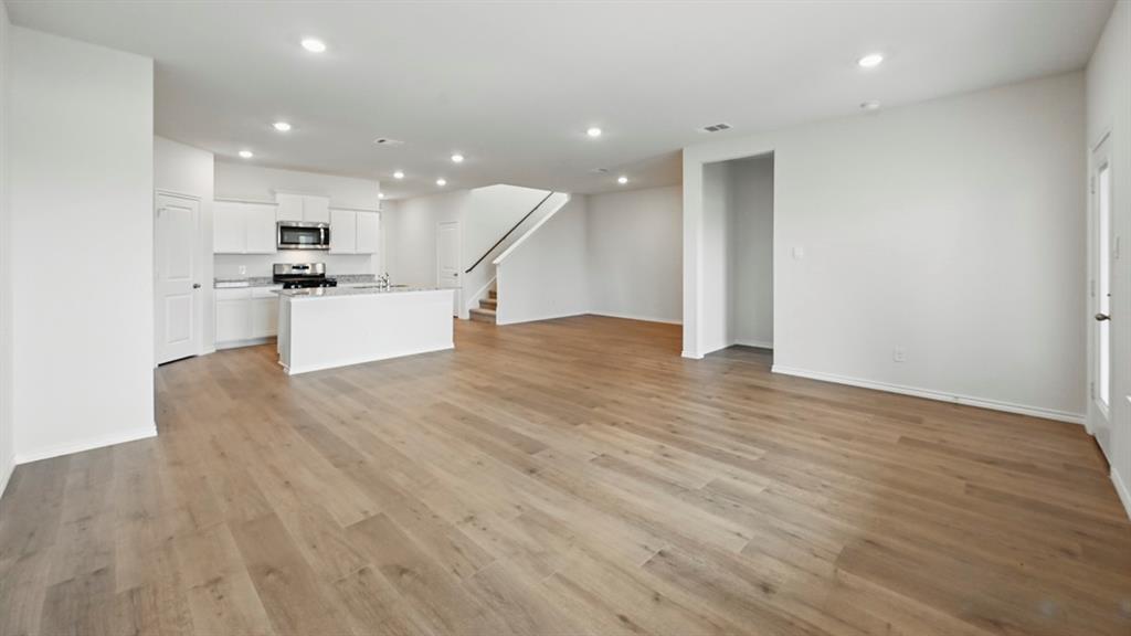 1608 Basalt Lane Celina, TX 75009 - Photo 27 of 36 a view of kitchen with kitchen island microwave and stove