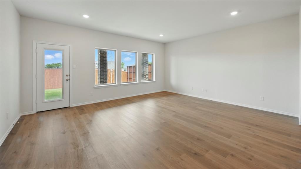 1608 Basalt Lane Celina, TX 75009 - Photo 31 of 36 a view of empty room with wooden floor and fan