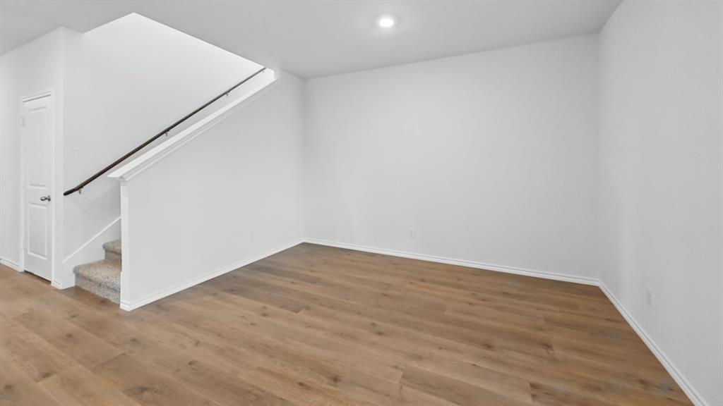 1608 Basalt Lane Celina, TX 75009 - Photo 34 of 36 an empty room with wooden floor and white walls