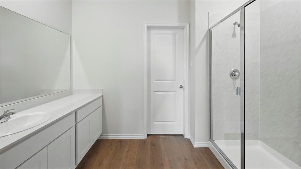1608 Basalt Lane Celina, TX 75009 - Photo 4 of 36 a bathroom with a sink and a mirror