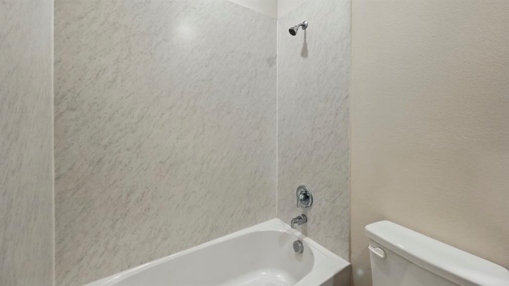 1608 Basalt Lane Celina, TX 75009 - Photo 6 of 36 a bathroom with a bathtub and a toilet
