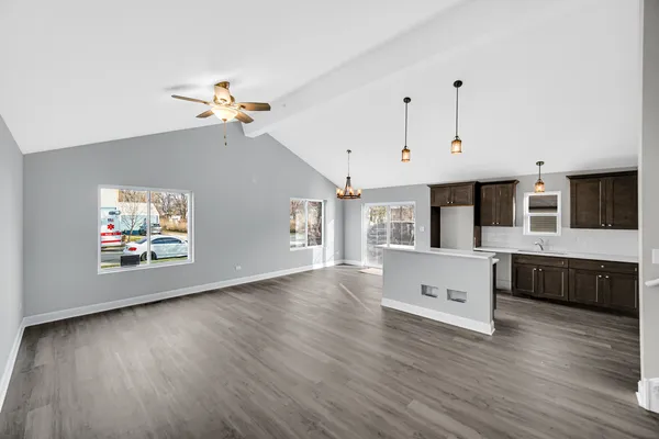 a view of living room with furniture and wooden floor