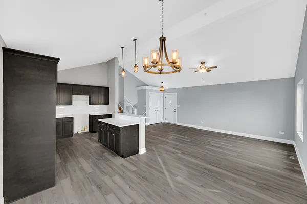 a kitchen with a sink cabinets and wooden floor