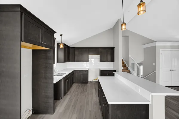 a kitchen with stainless steel appliances a sink and cabinets