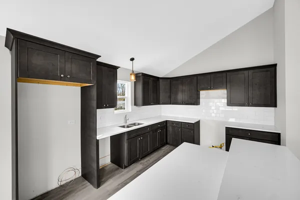 a kitchen with stainless steel appliances a sink and a refrigerator