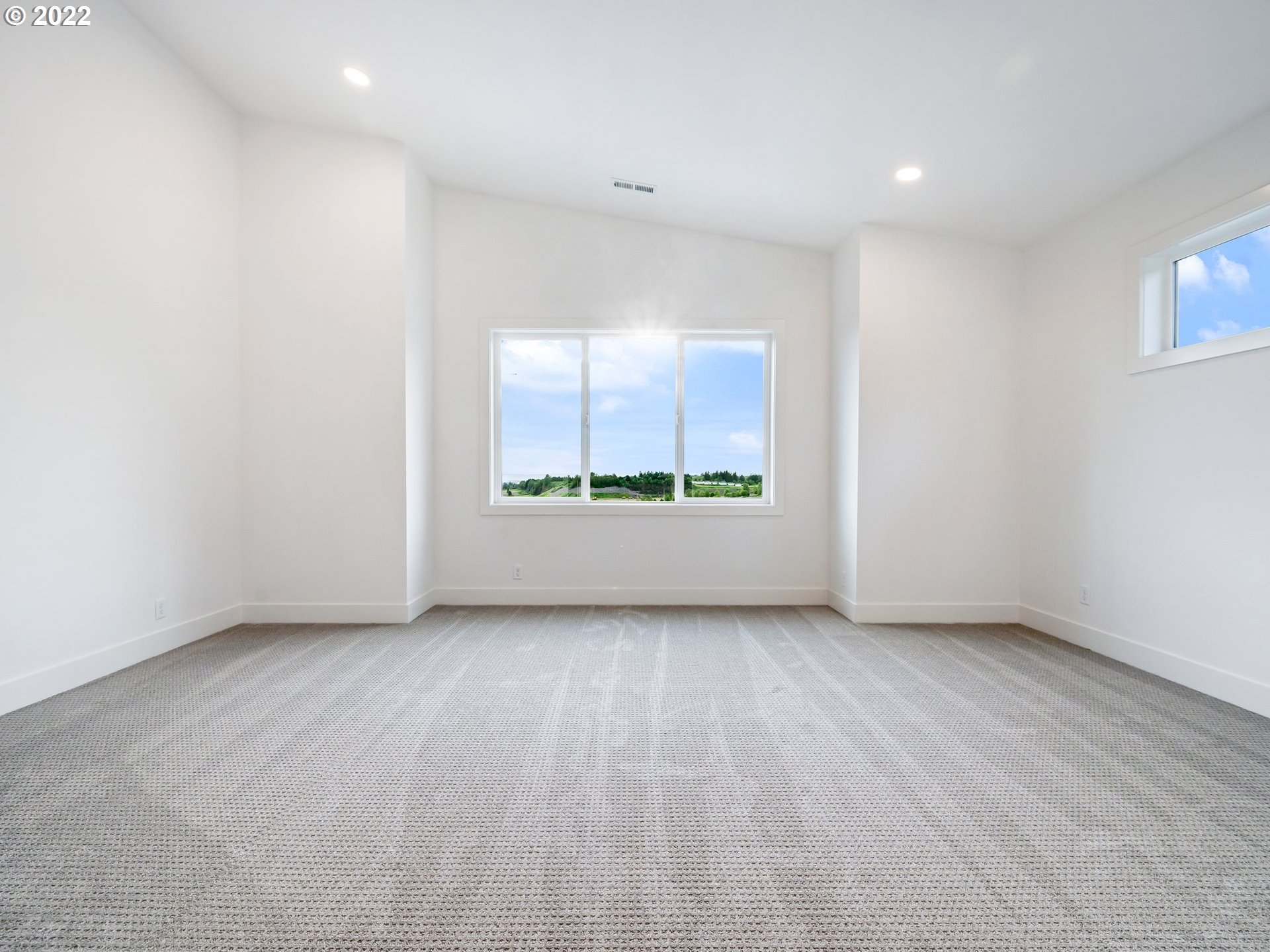 4713 Southeast Ascension Drive Camas, WA 98607 - Photo 27 of 32 an empty room with wooden floor and windows