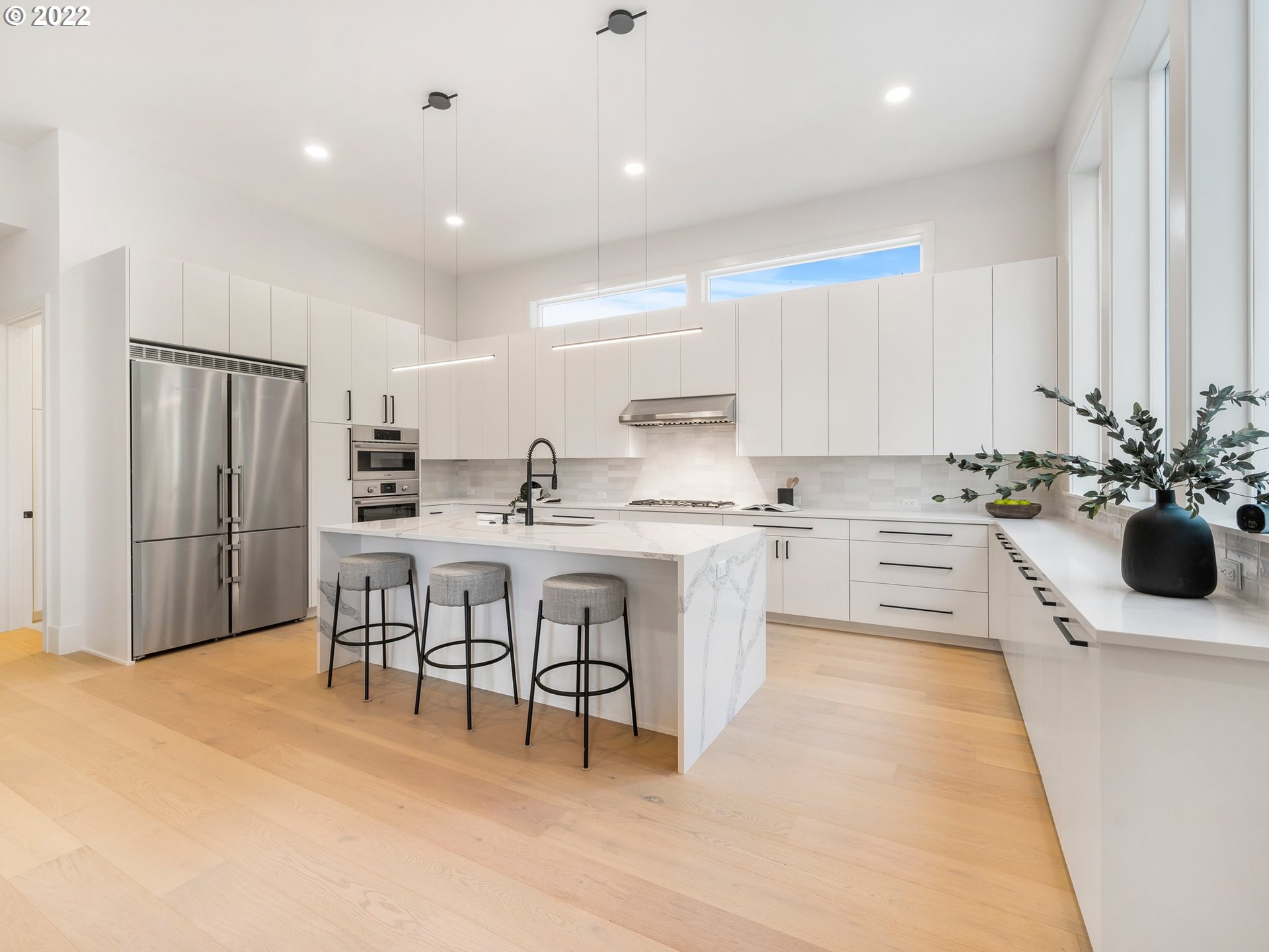 4713 Southeast Ascension Drive Camas, WA 98607 - Photo 6 of 32 a kitchen with a sink chairs and white cabinets