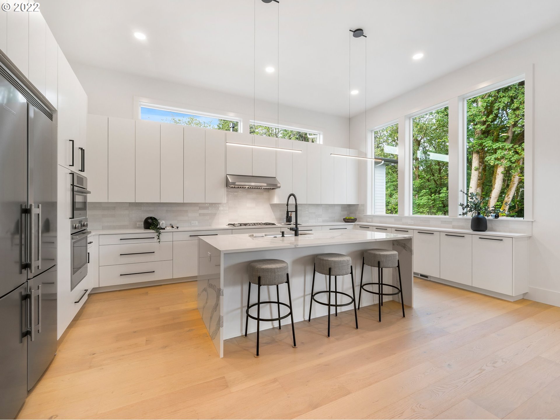 4713 Southeast Ascension Drive Camas, WA 98607 - Photo 8 of 32 a kitchen with kitchen island a large window in it and appliances