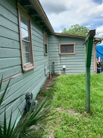 a backyard of a house with table and chairs