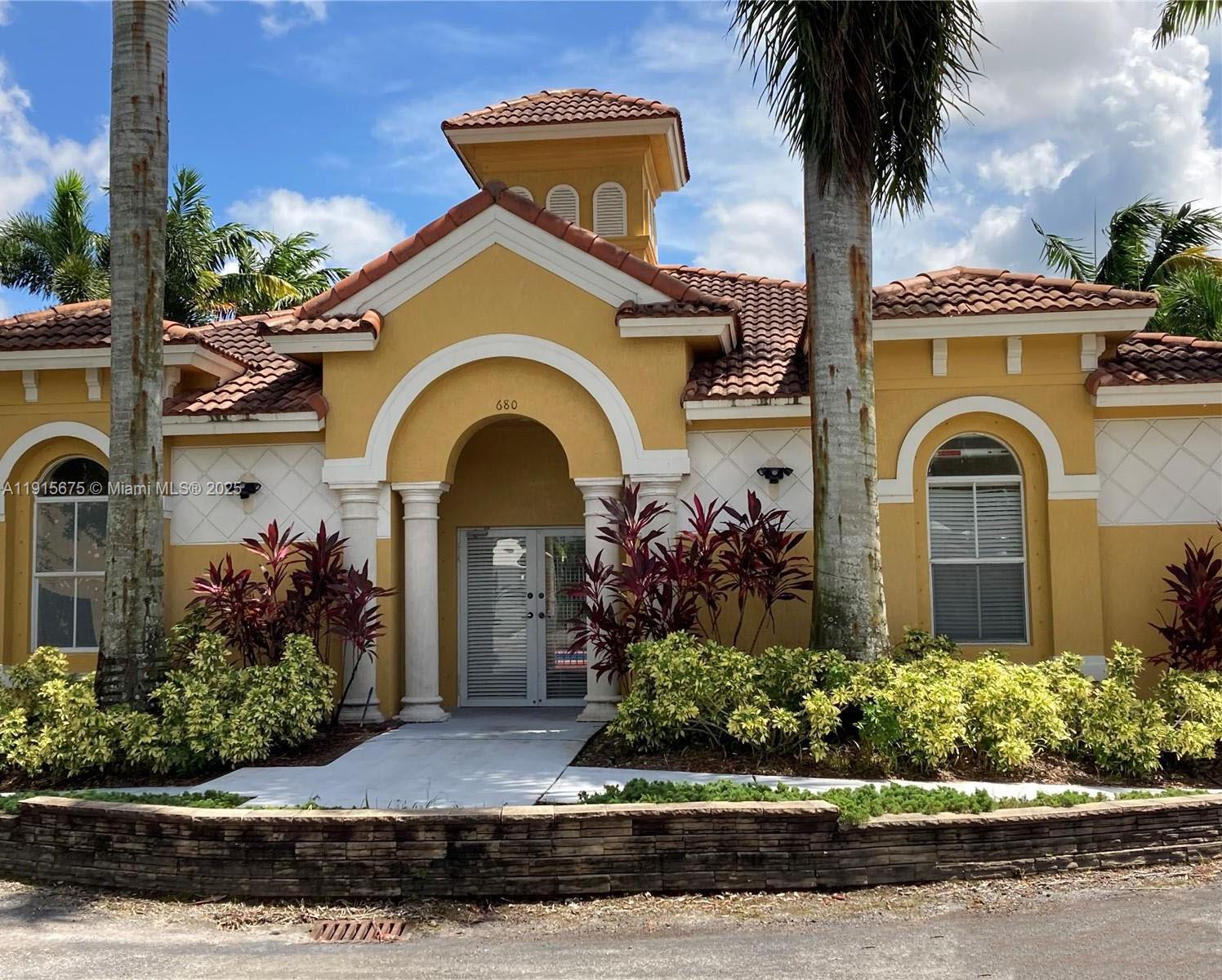 761 Southeast 2nd Street, Unit 761 Homestead, FL 33030 - Photo 11 of 12 a front view of a house with a garden