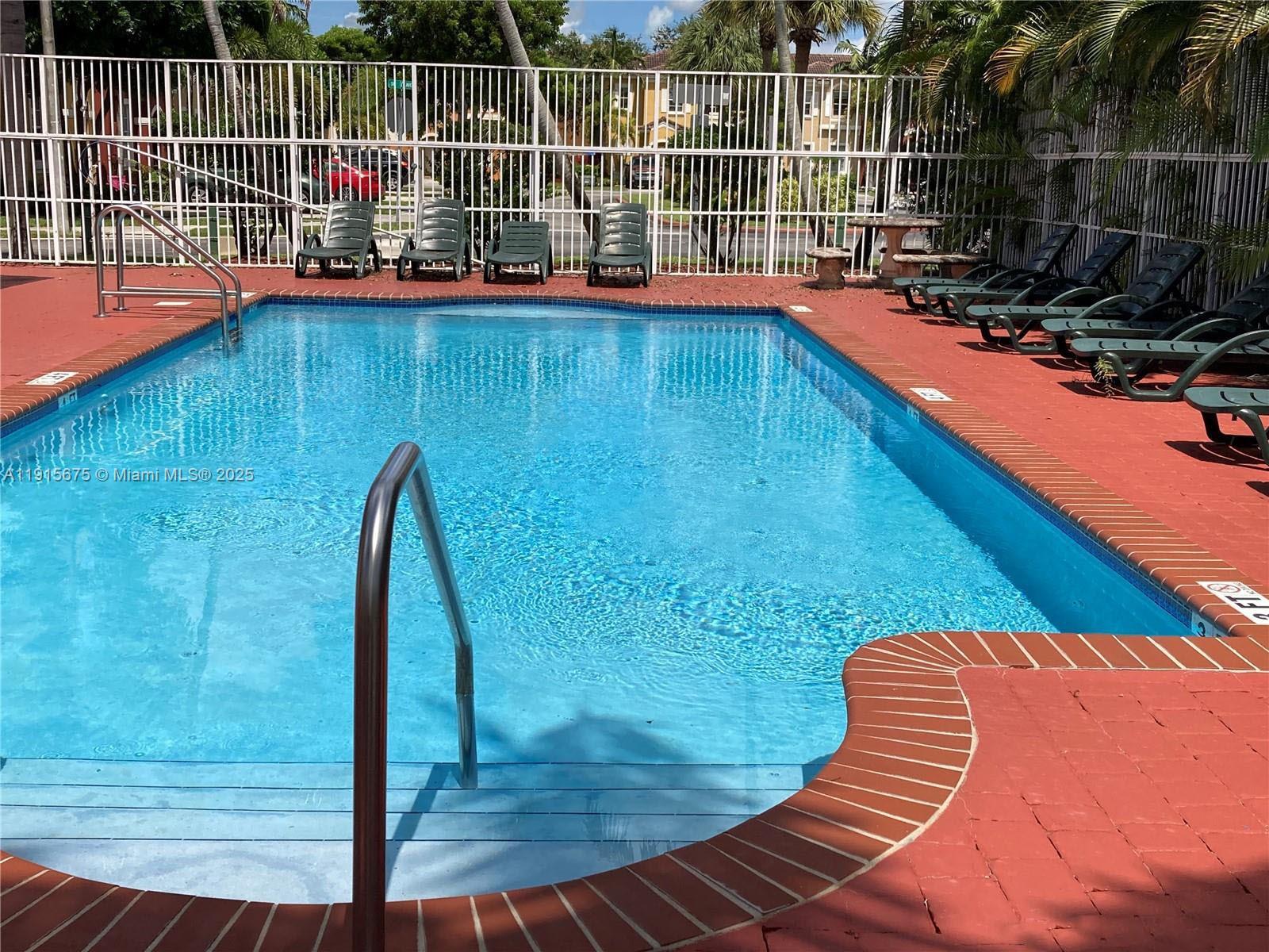 761 Southeast 2nd Street, Unit 761 Homestead, FL 33030 - Photo 12 of 12 a view of a swimming pool with a lounge chair