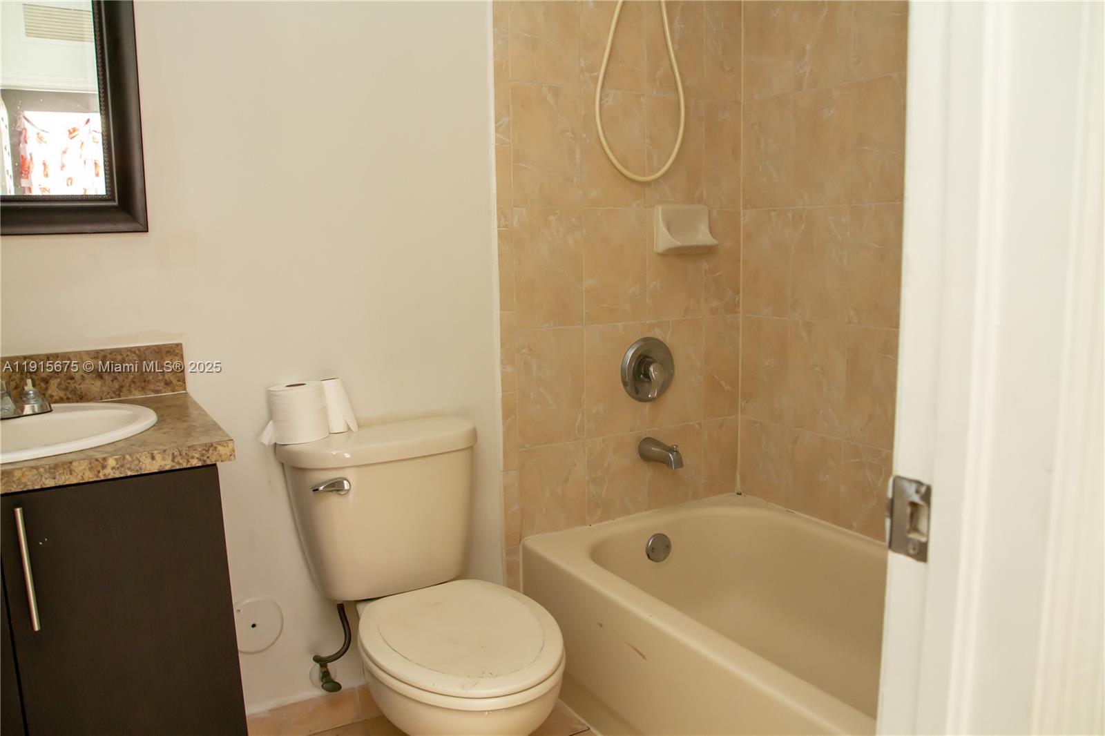 761 Southeast 2nd Street, Unit 761 Homestead, FL 33030 - Photo 5 of 12 a white toilet sitting next to a bath tub shower