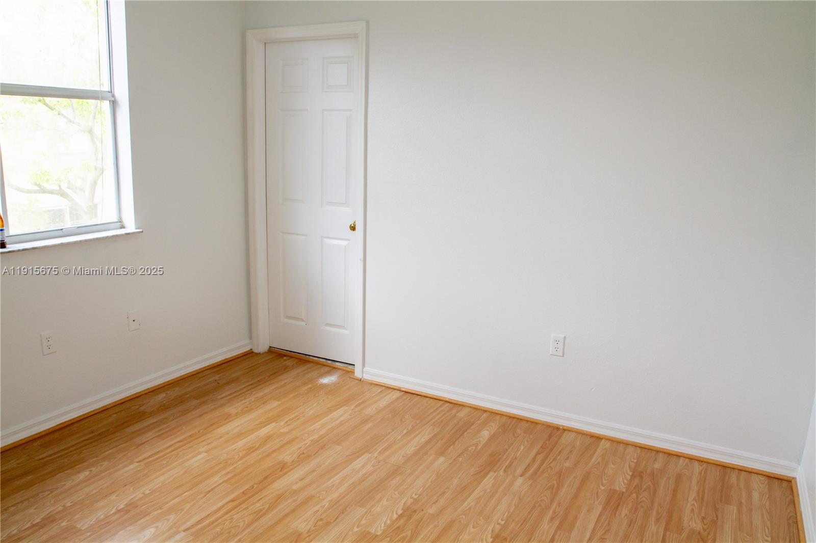 761 Southeast 2nd Street, Unit 761 Homestead, FL 33030 - Photo 9 of 12 an empty room with wooden floor and windows