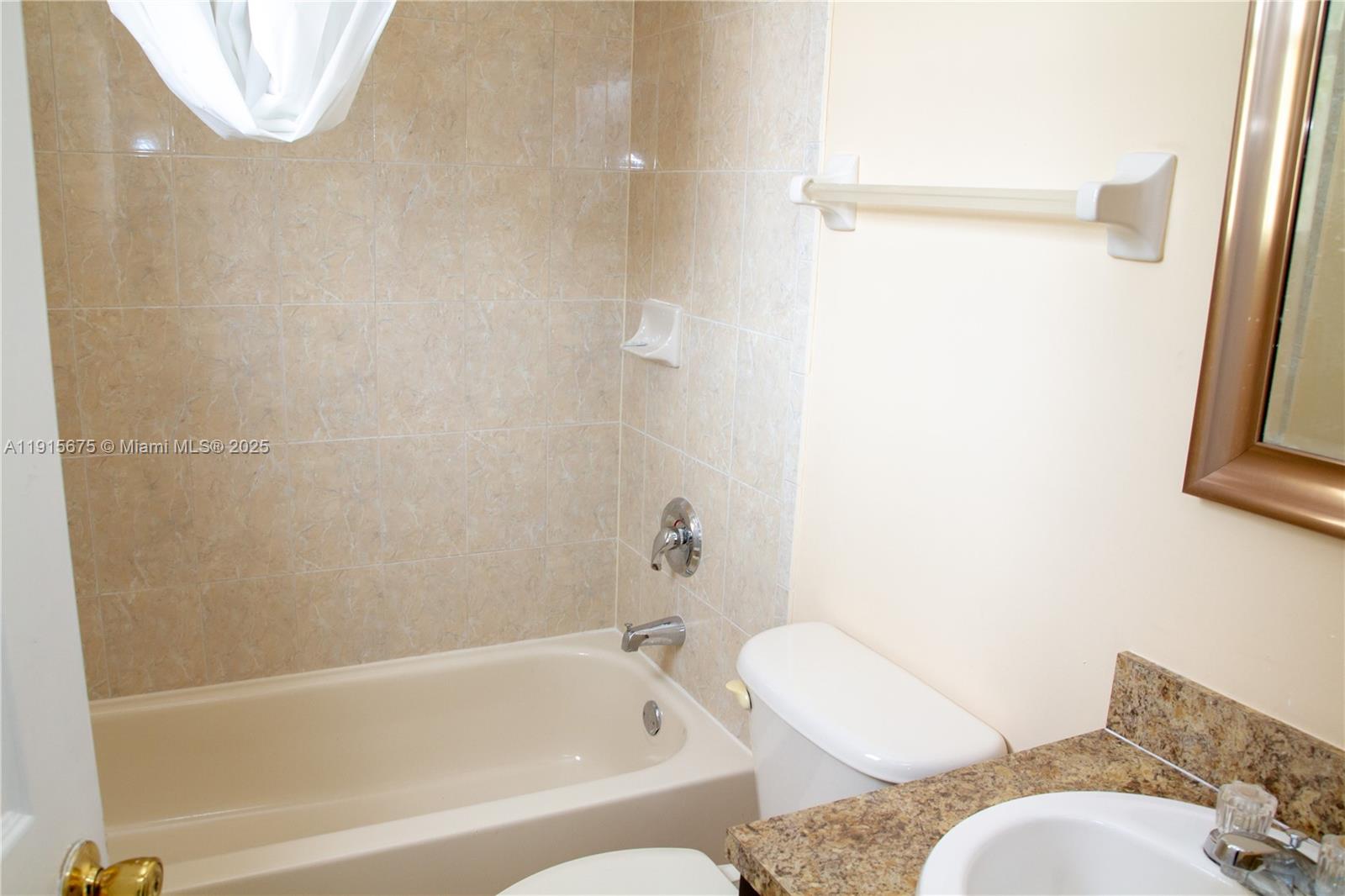 761 Southeast 2nd Street, Unit 761 Homestead, FL 33030 - Photo 10 of 12 a bathroom with a toilet and a bathtub