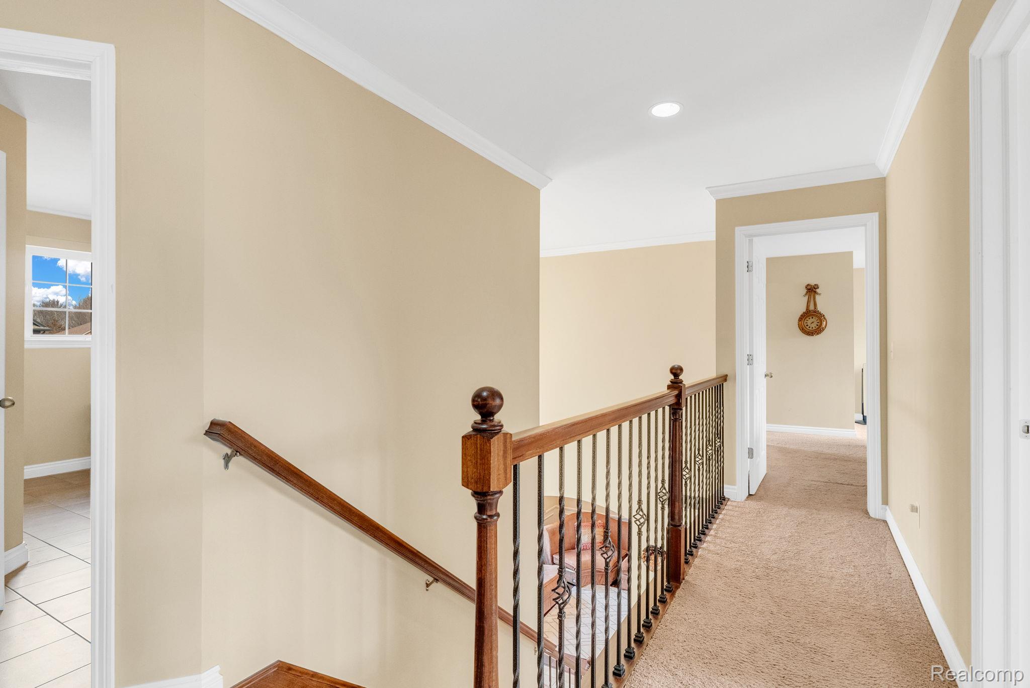 4122 Hawks Nest Road Utica, MI 48317 - Photo 37 of 74 Hallway featuring ornamental molding, an upstairs landing, and recessed lighting