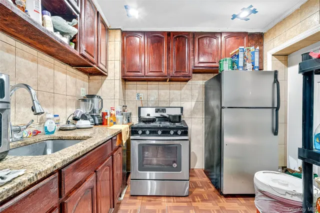 a kitchen with a sink stove and refrigerator