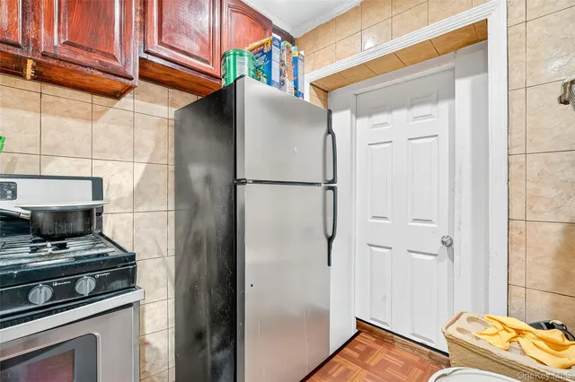 a kitchen with a refrigerator and a stove
