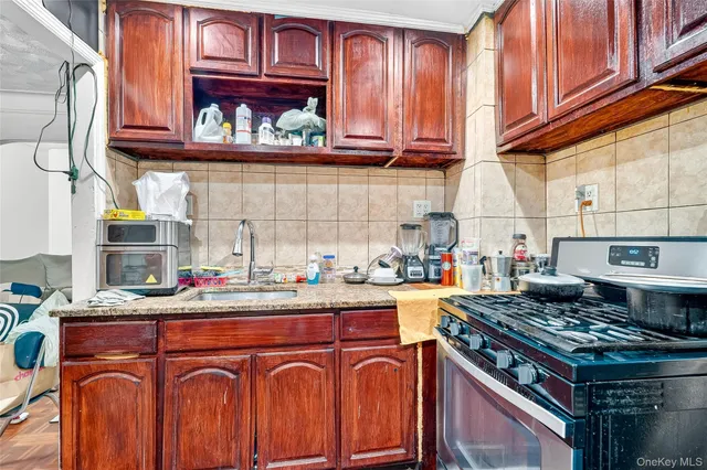 a kitchen with stainless steel appliances granite countertop a stove and a sink