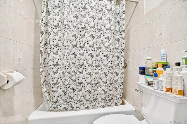 a living room with furniture a couch and a bookshelf