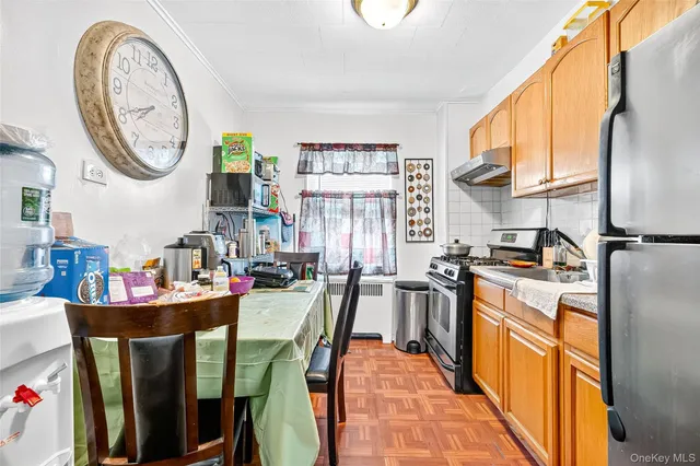 a kitchen with stainless steel appliances granite countertop a stove a sink a refrigerator and cabinets