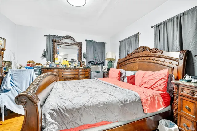 a bedroom with bed and cabinets