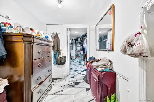 a living room with lots of storage and a bed