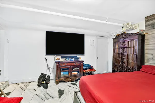 a bedroom with a bed and flat screen tv
