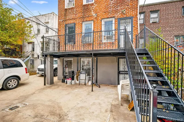 a view of a balcony with wooden floor and fence