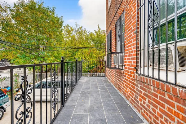 a view of a balcony with wooden floor and fence