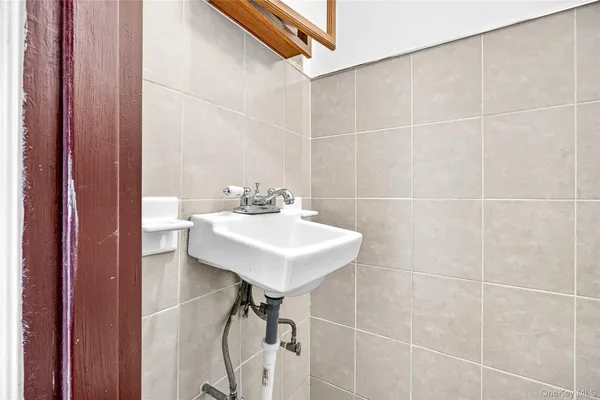 a bathroom with a sink mirror and a shower