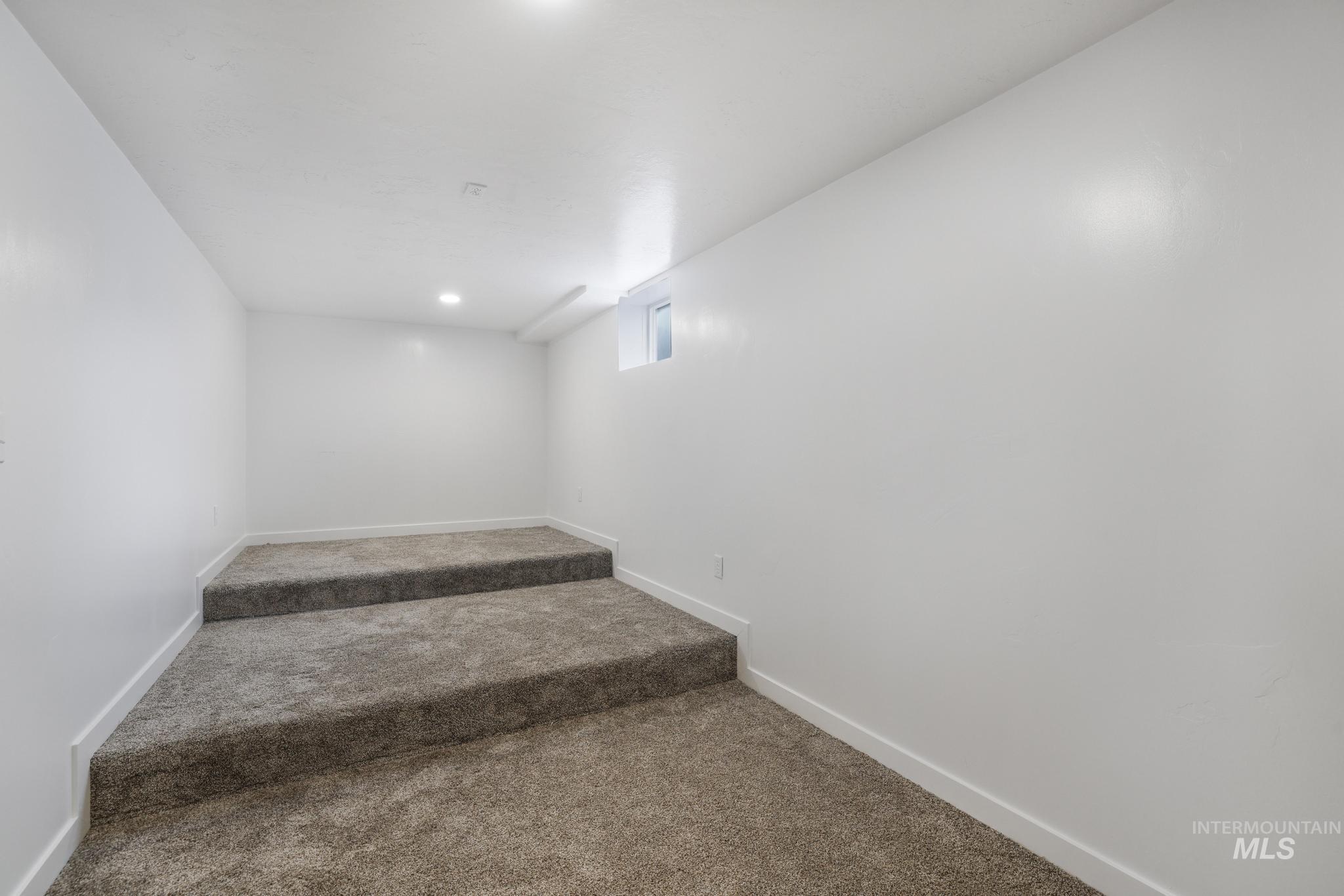 201 East 27th Street Burley, ID 83318 - Photo 11 of 19 Stairway featuring baseboards and carpet flooring